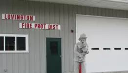 A statue in front of a fire department office